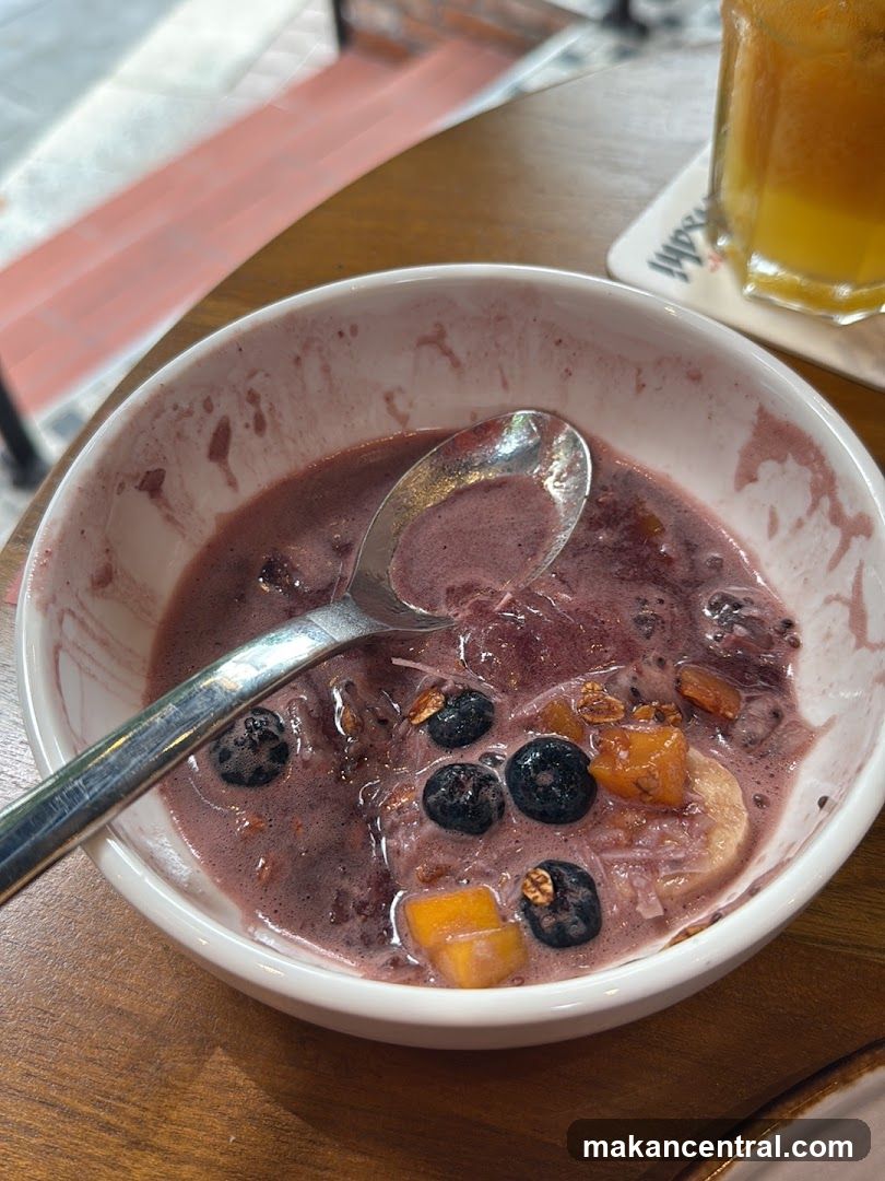 Partially Eaten Acai Bowl with Fruit and Granola