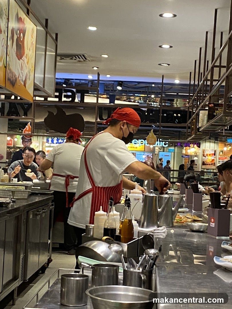 Chefs preparing food at a counter