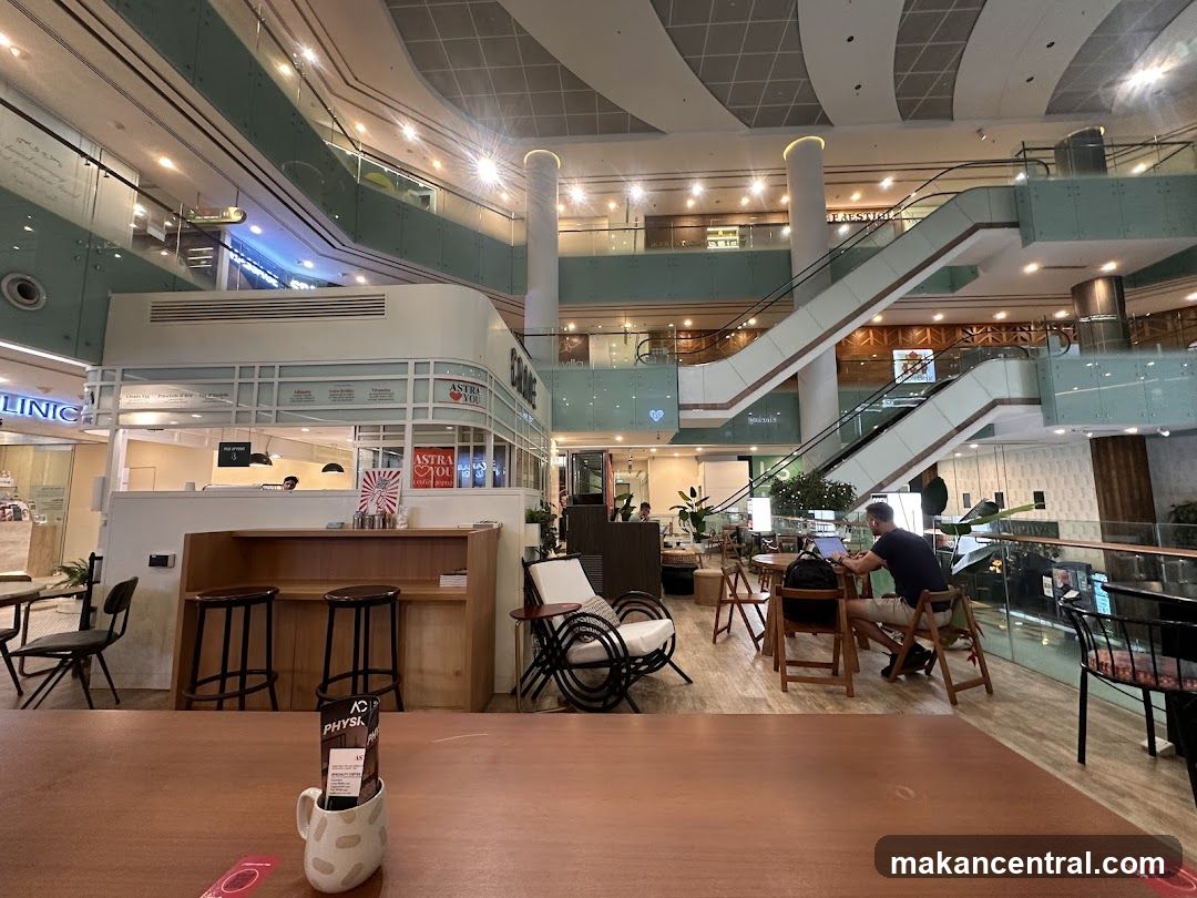 Interior of a modern shopping mall with a cafe