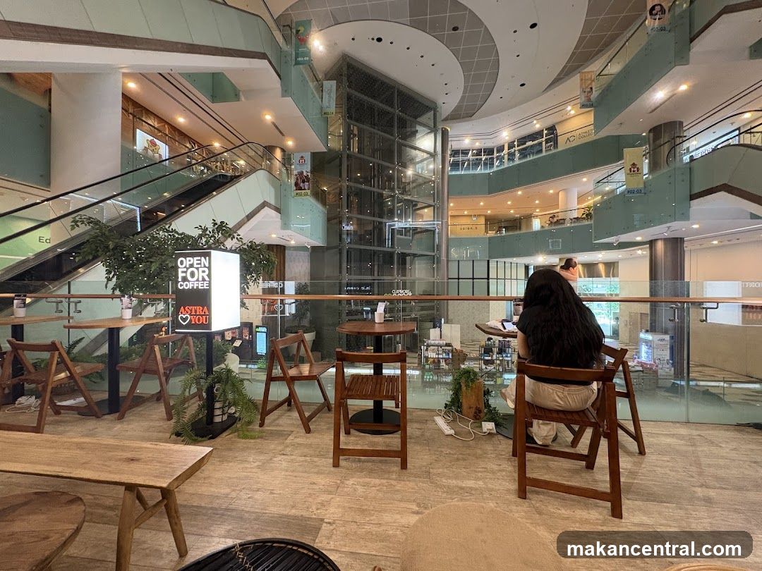 Cafe interior with a person working on a laptop