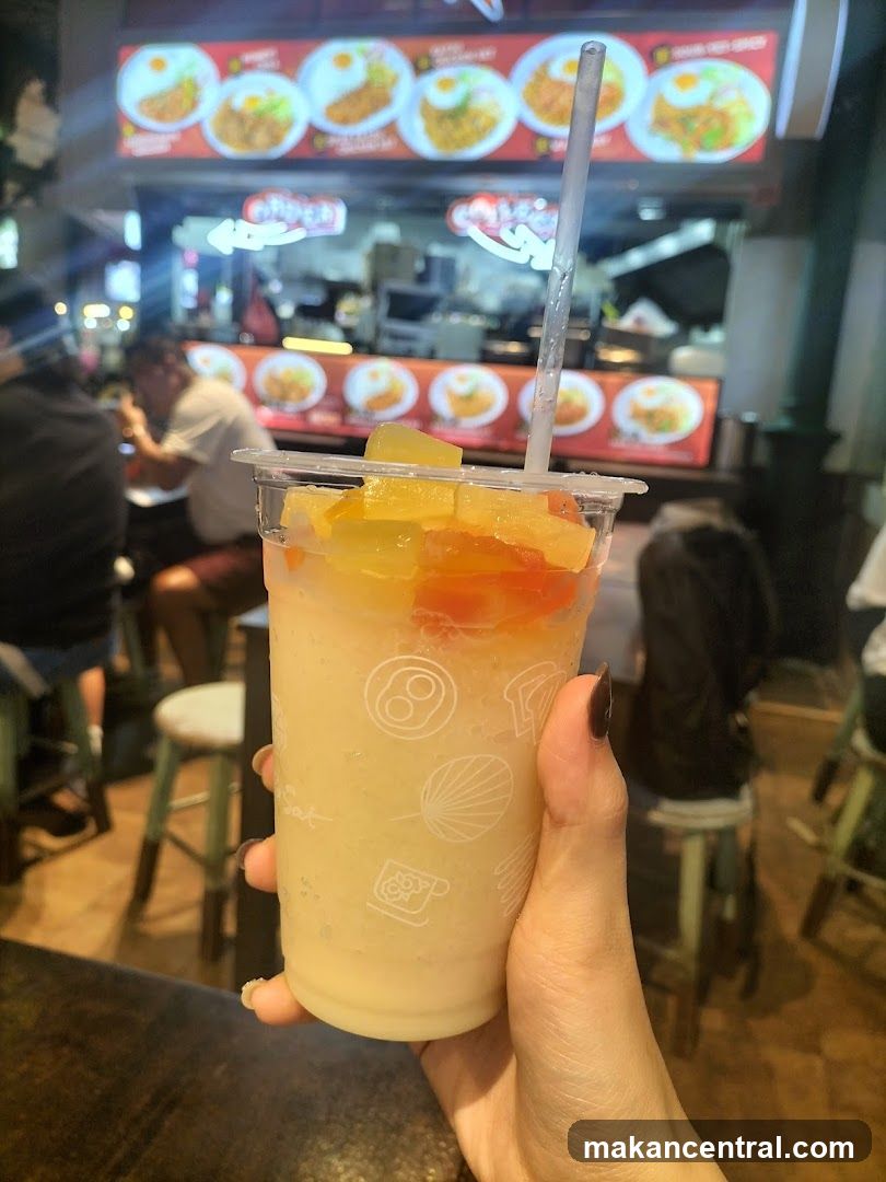 Fruit Smoothie with Food Stall in Background