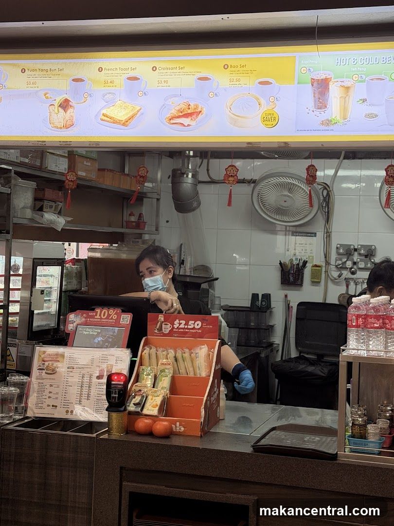 Food counter with menu board and staff