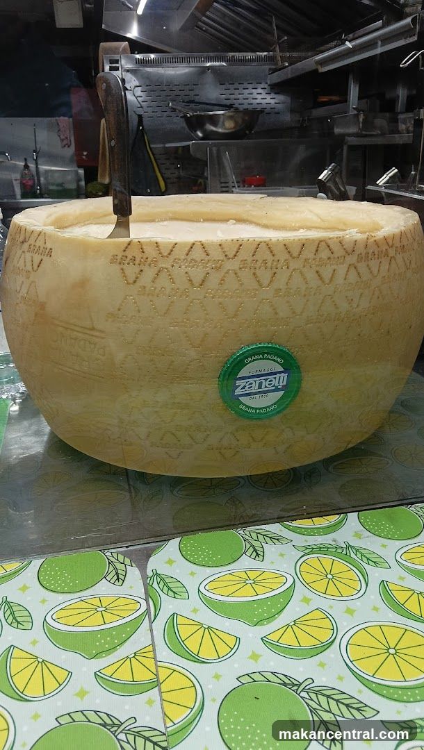 Large wheel of cheese with knife