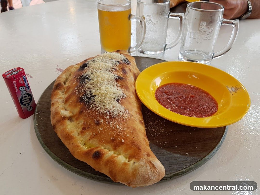 Calzone with Dipping Sauce and Beer