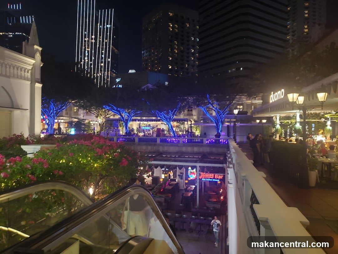Night view of a lively outdoor dining and bar area