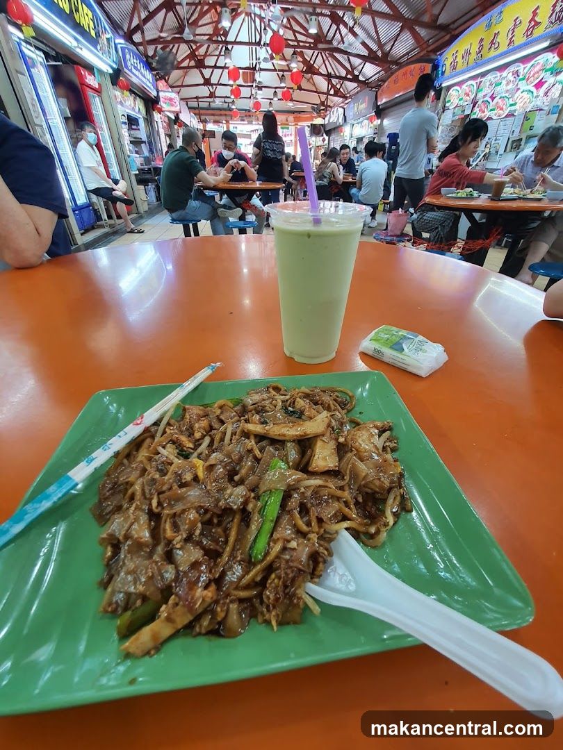 Food court scene with char kway teow and drink