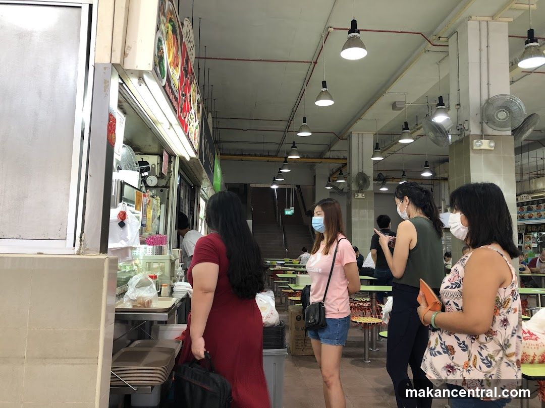 People queuing at a food stall