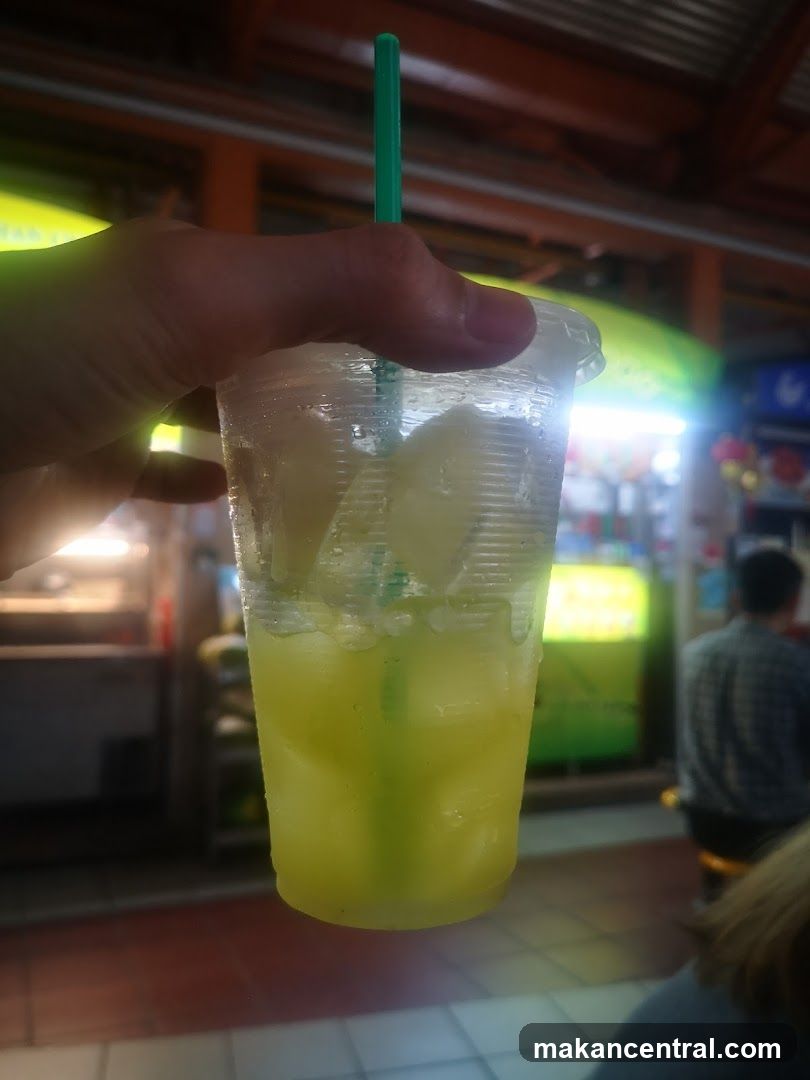 Hand holding a drink with ice