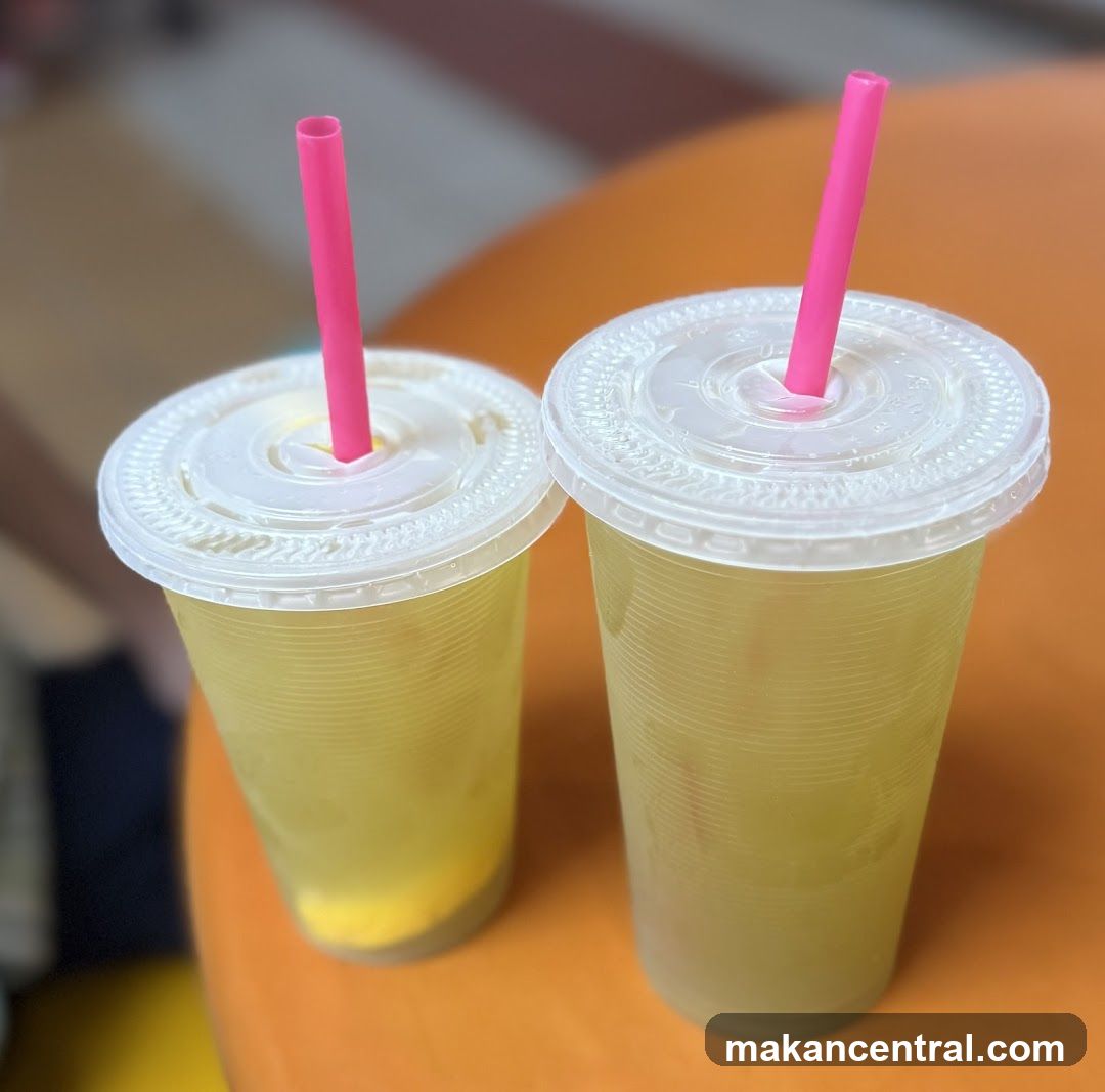 Two drinks with pink straws