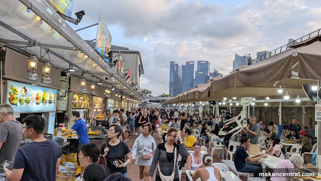 Outdoor Food Stalls with City Skyline