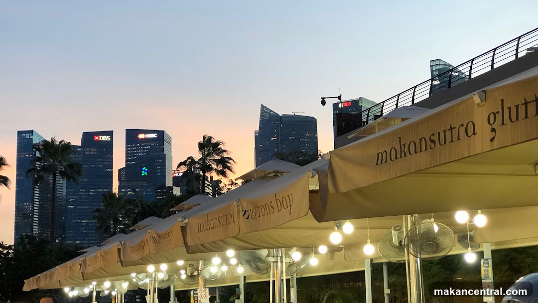 Outdoor Seating Area with City Skyline at Dusk