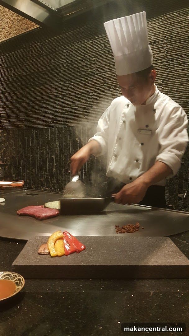 Chef cooking at a teppanyaki grill