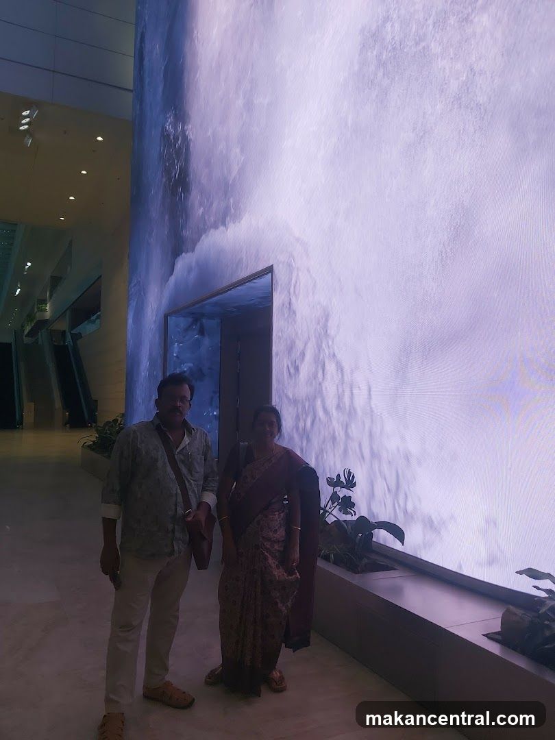 People in front of a large digital waterfall display