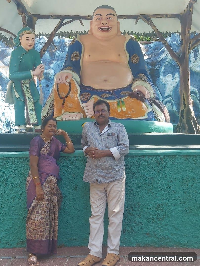 Couple Poses in Front of Statues