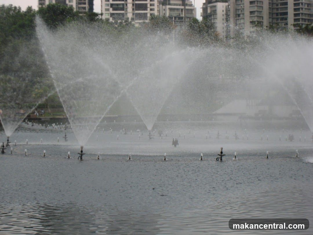 Fountain display with city buildings in the background