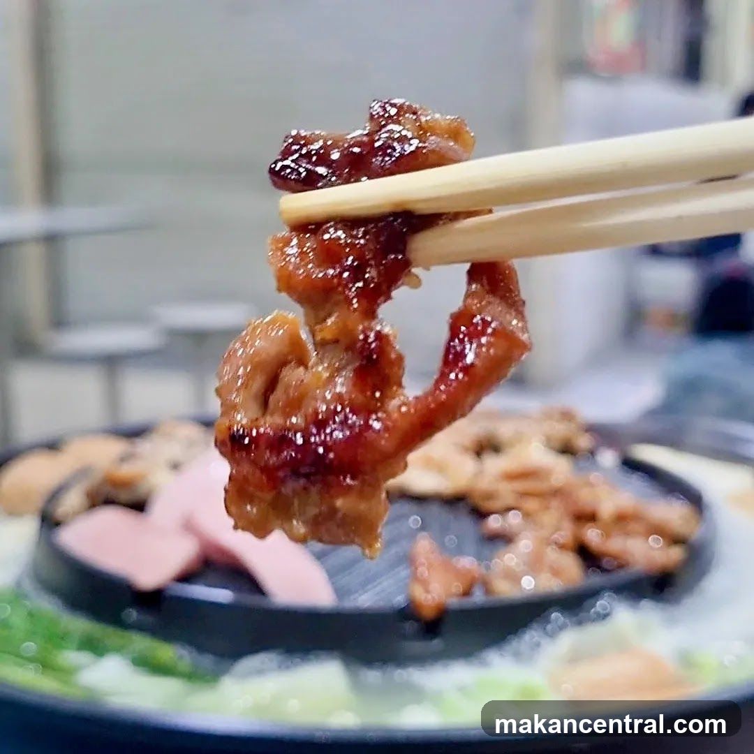 Close-up of Marinated Meat on Chopsticks