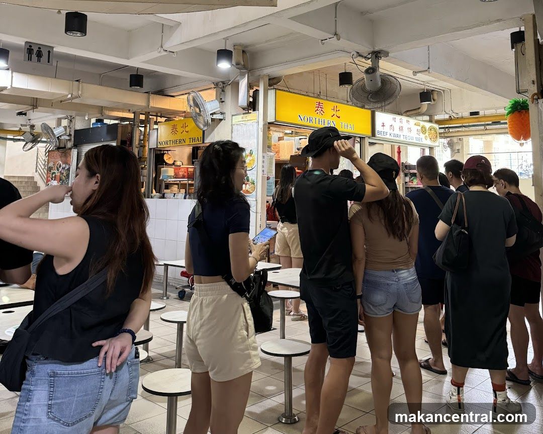 People queuing at a food stall