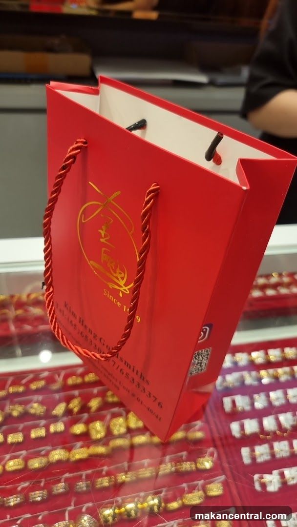 Red shopping bag with gold logo