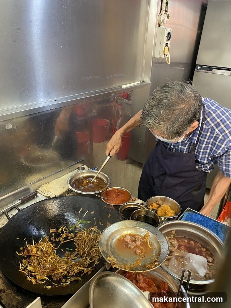 Cook preparing food in a wok