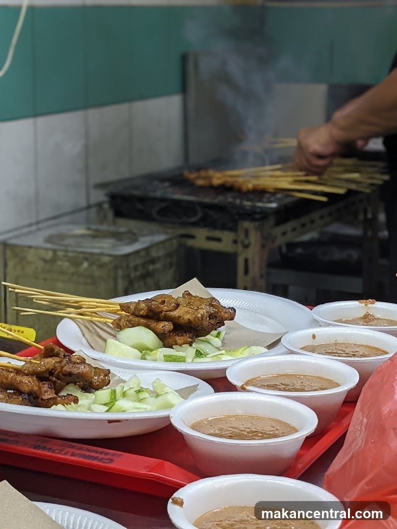 Satay being grilled and served