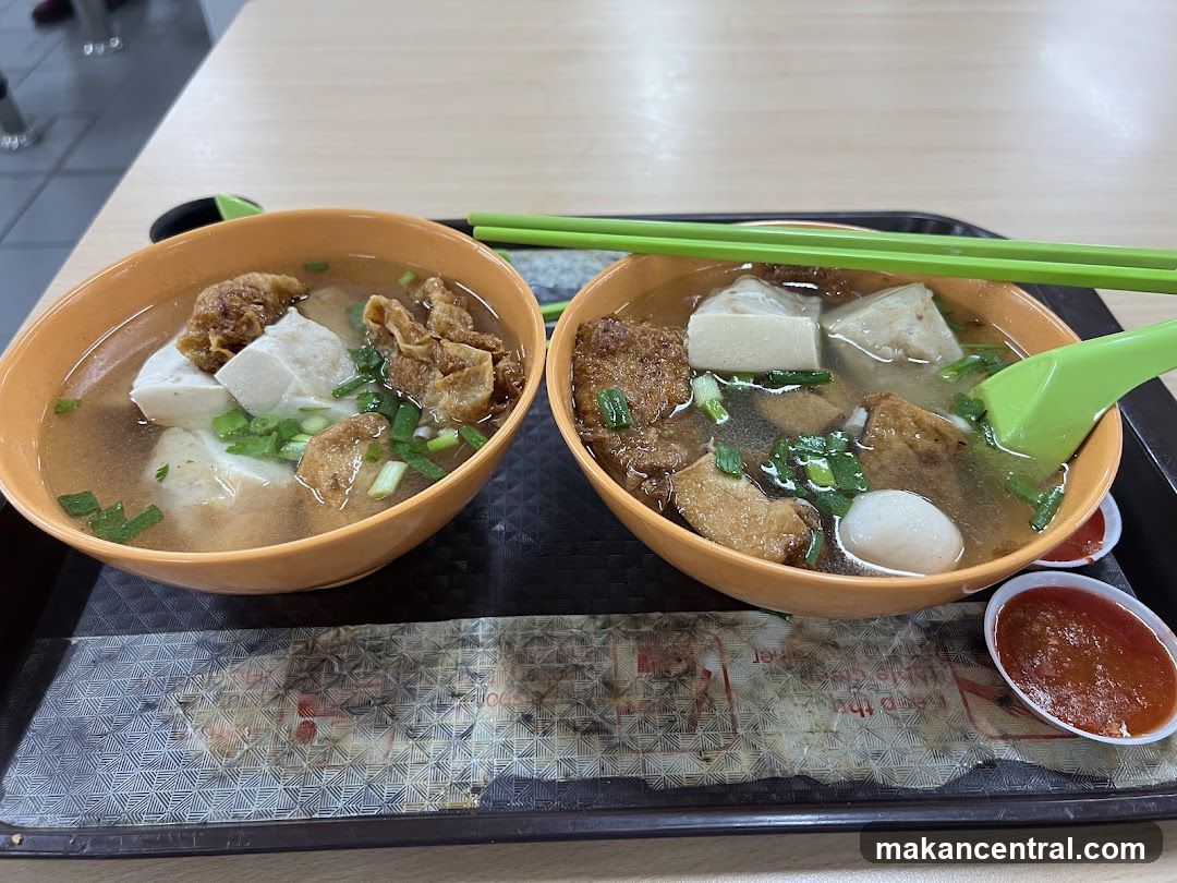 Two bowls of soup with tofu and fried items