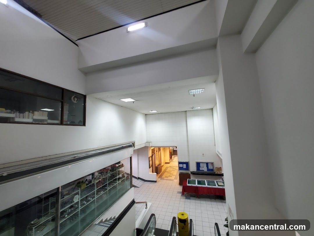 Interior of a building with escalators and display areas