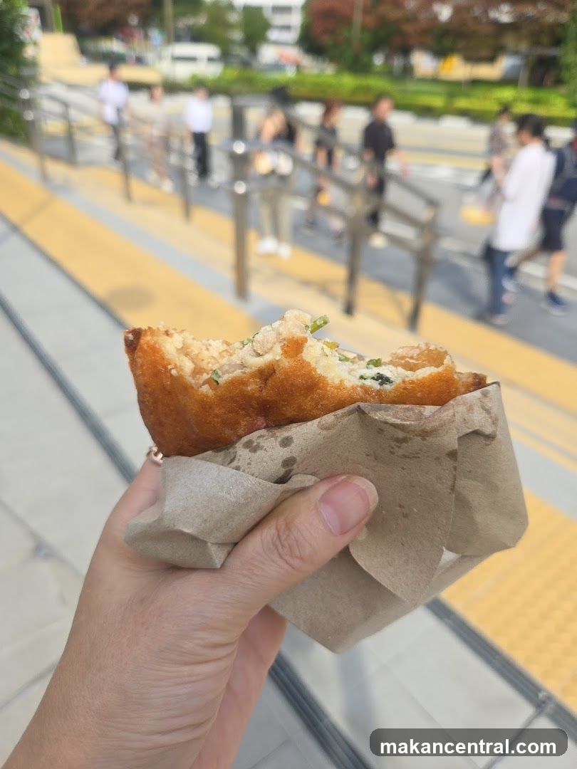 Hand holding a bite of food