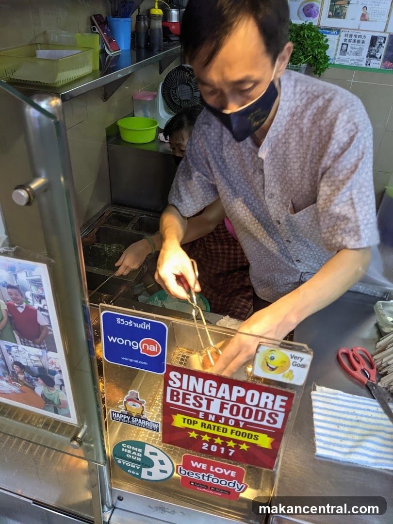 Food stall worker frying food