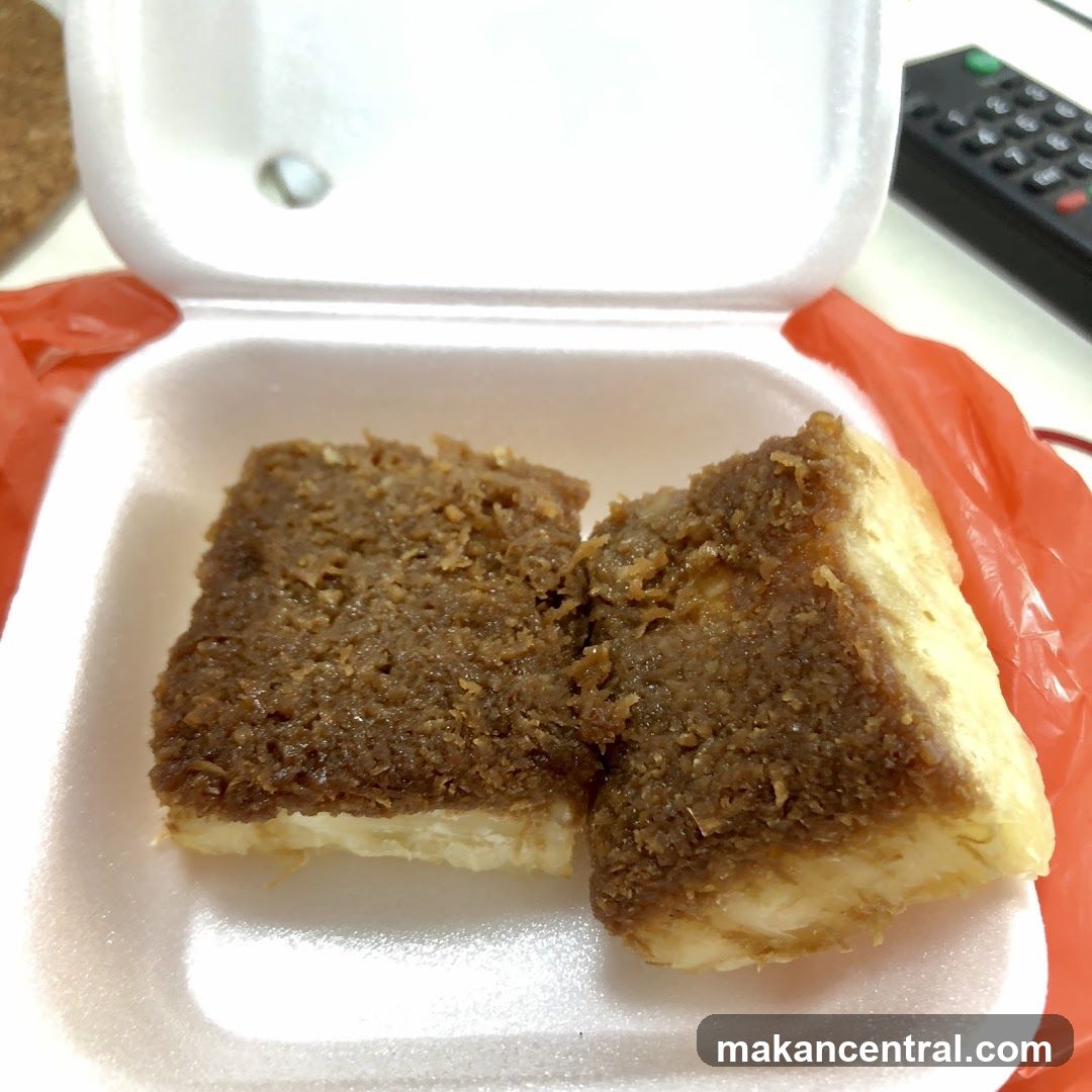 Two pieces of dessert in a takeout container