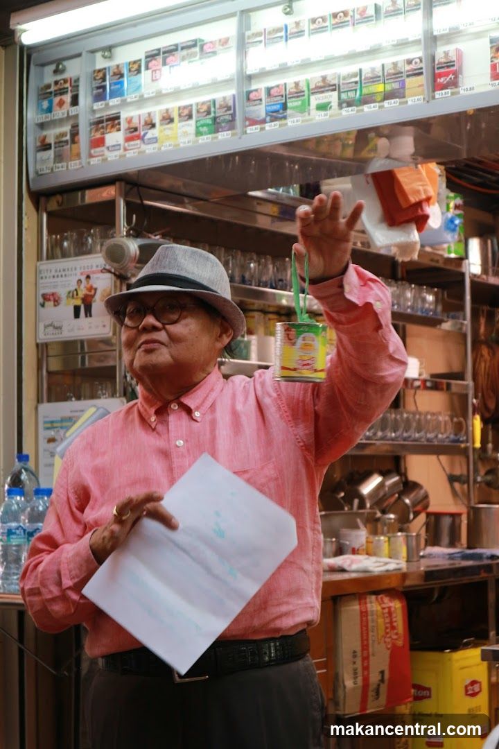 Man holding a can and paper