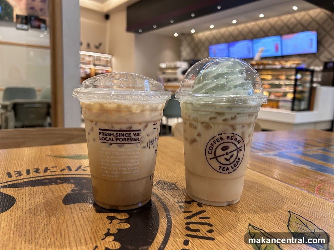 Two iced beverages on a wooden table