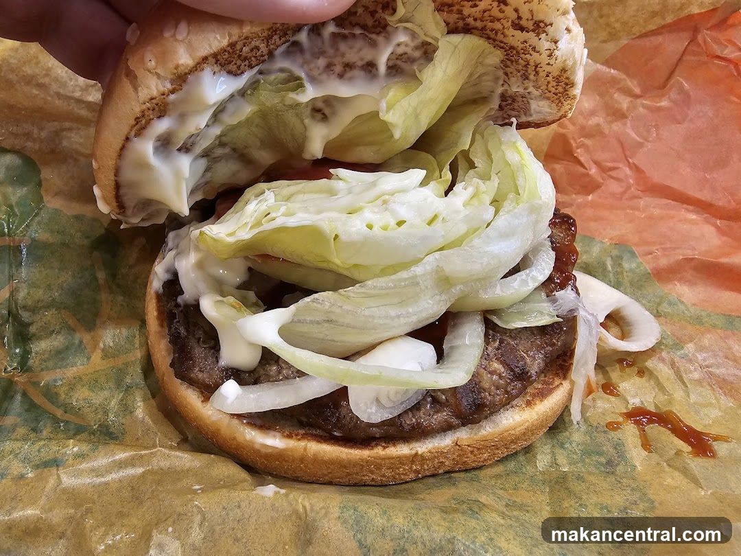 Burger with lettuce, onion, and sauce