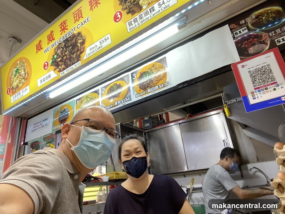 Food stall with menu and customers