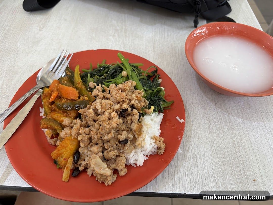 Rice plate with side dishes and a bowl of drink