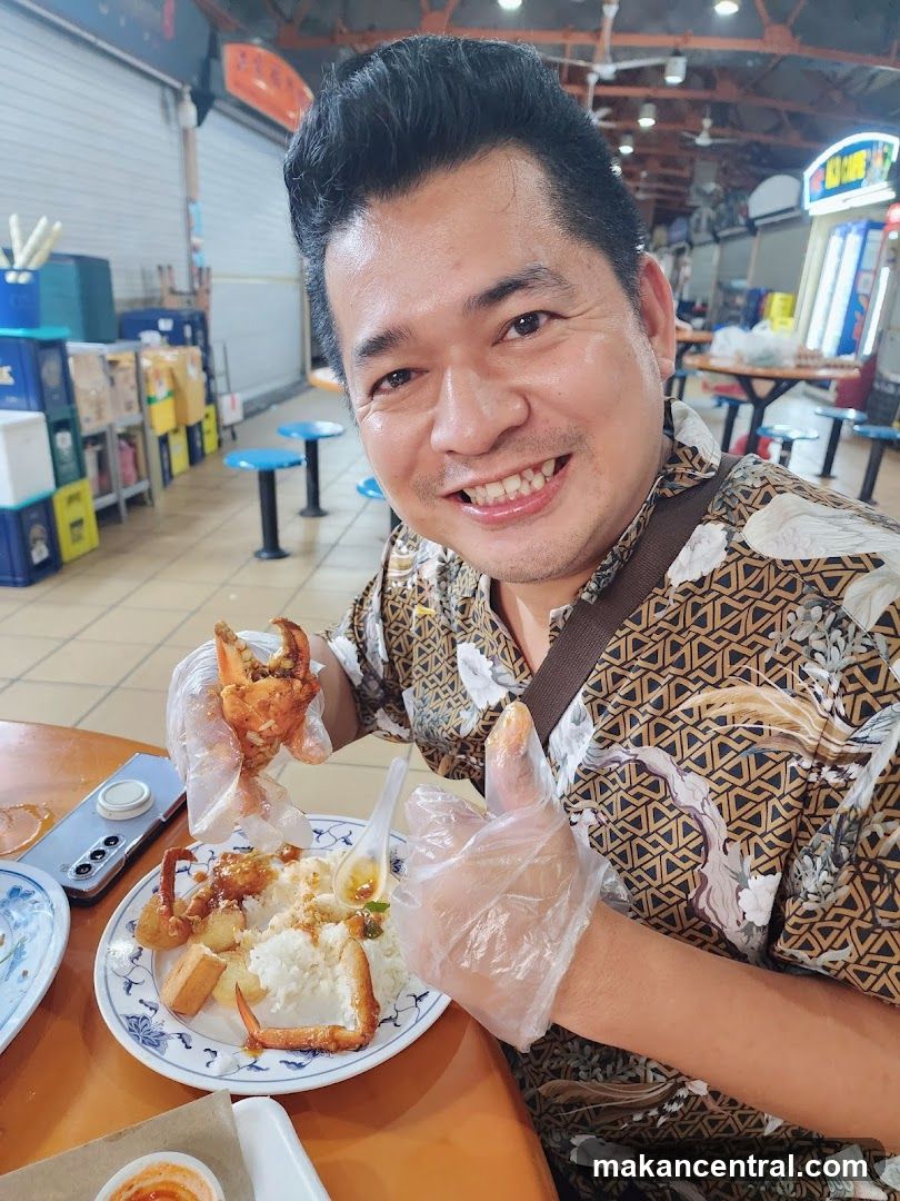 Man eating crab with rice