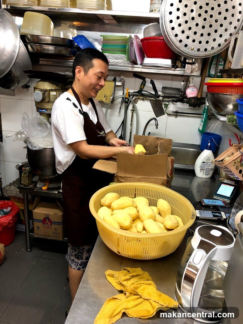Man peeling potatoes in a kitchen