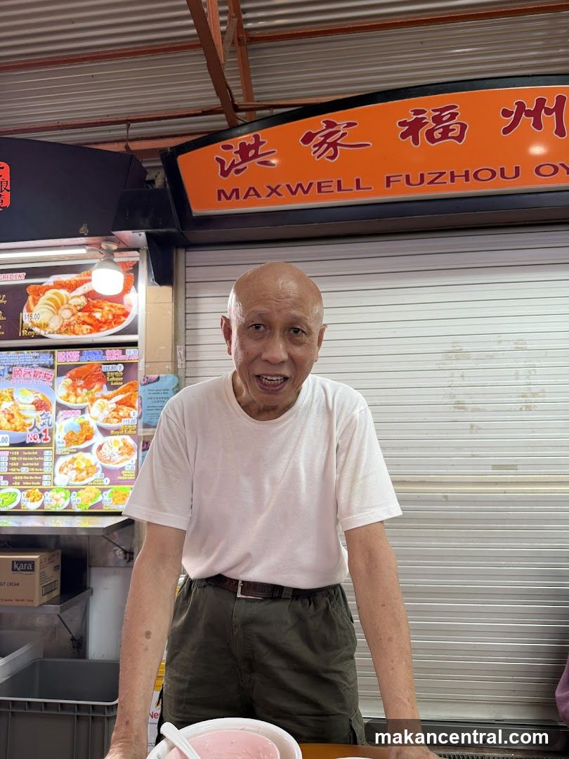 Man in front of a food stall