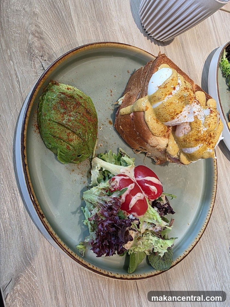 Eggs Benedict on Croissant with Avocado and Salad