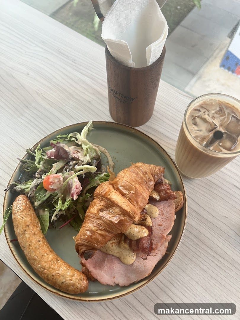 Croissant Sandwich with Sausage and Salad