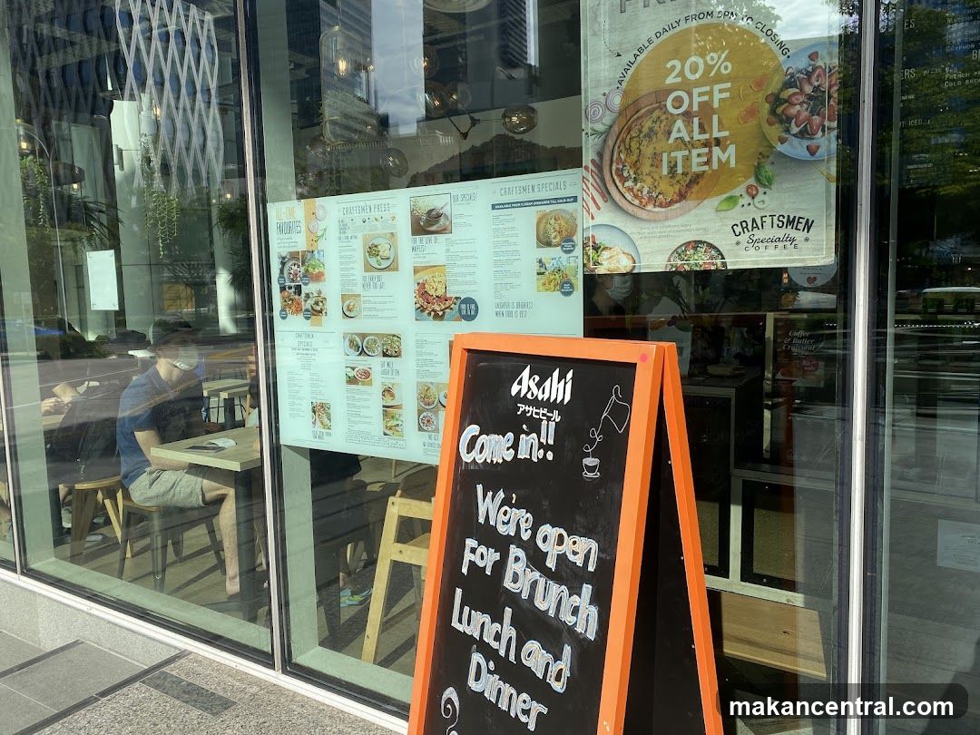 Cafe storefront with menu and promotional sign