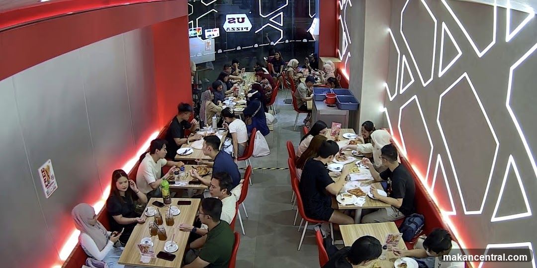 People eating pizza in a restaurant