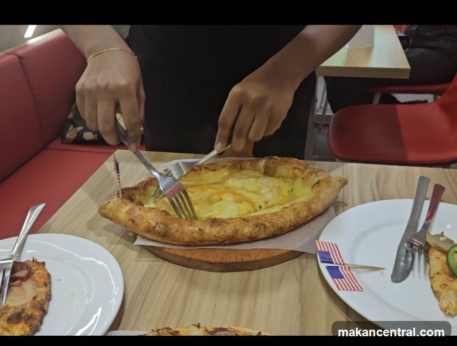 Person cutting a cheese-filled bread dish