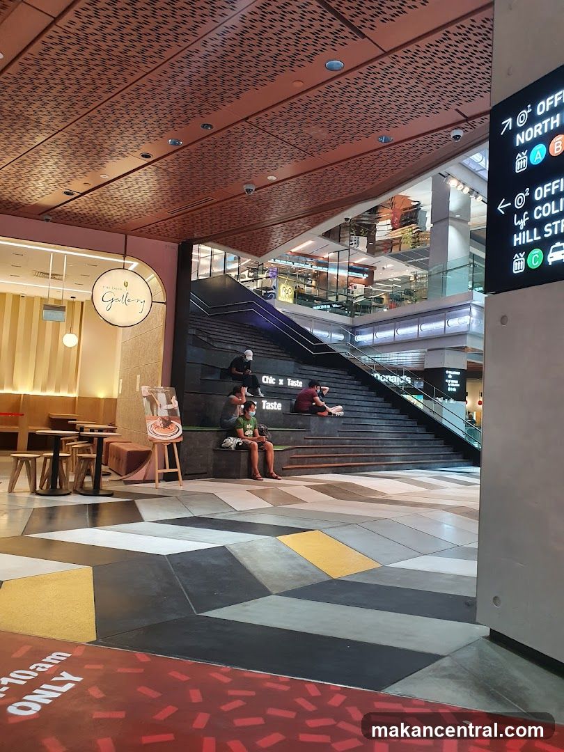 Indoor mall with seating area and directional signs