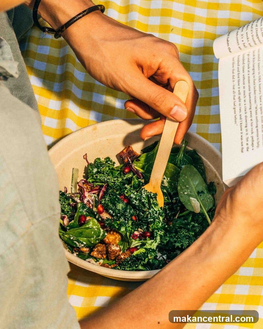 Person eating salad while reading