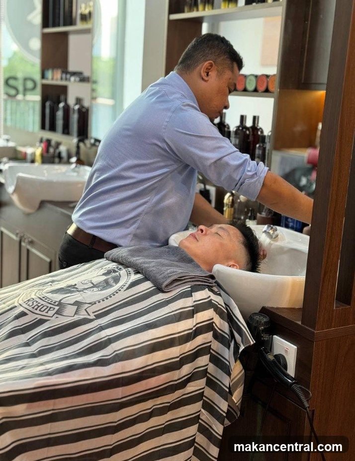 Barber washing client's hair