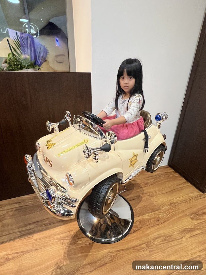 Child in a police car-themed chair