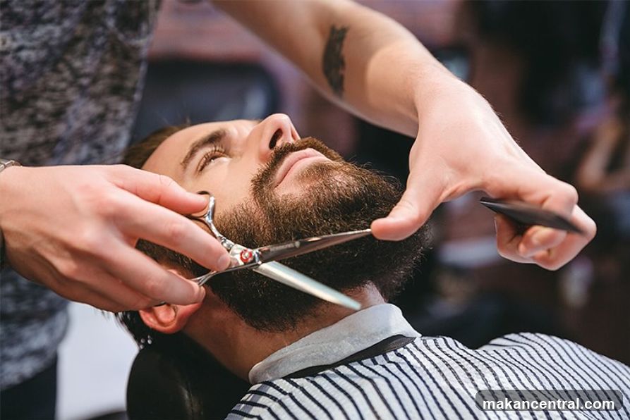 Barber trimming a beard
