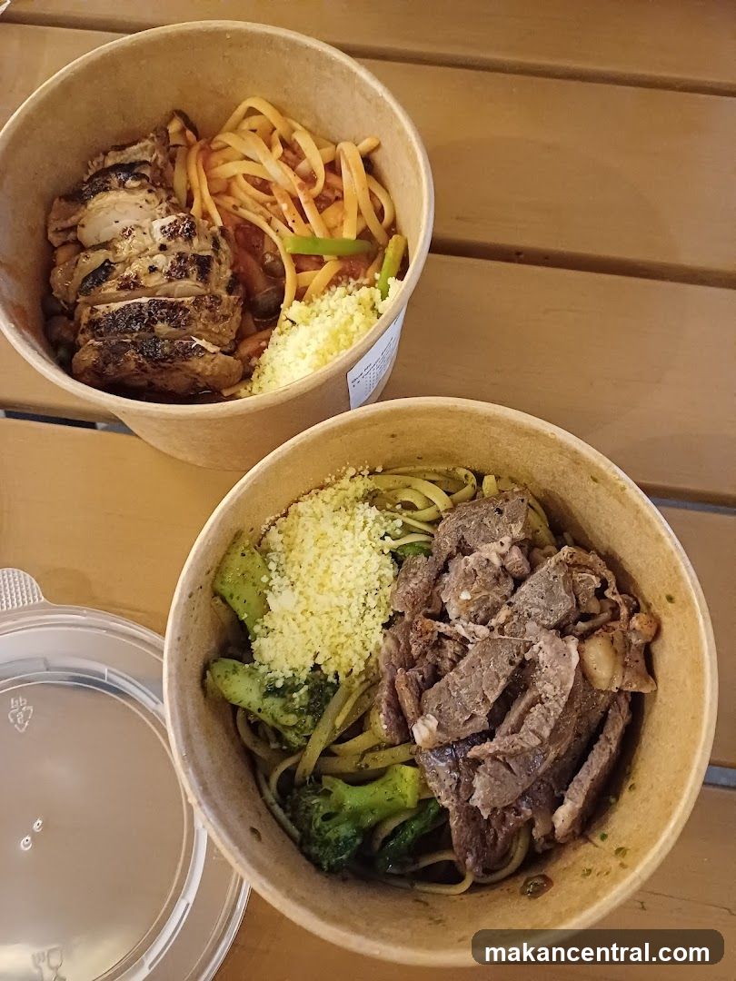 Two bowls of pasta with meat and vegetables
