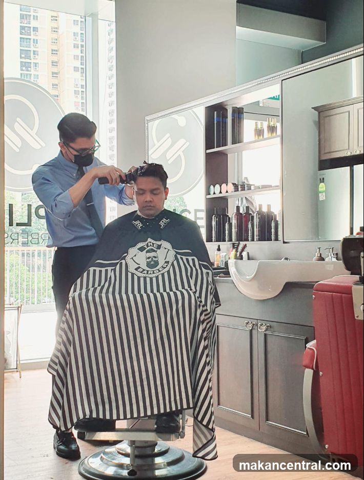 Barber cutting client's hair