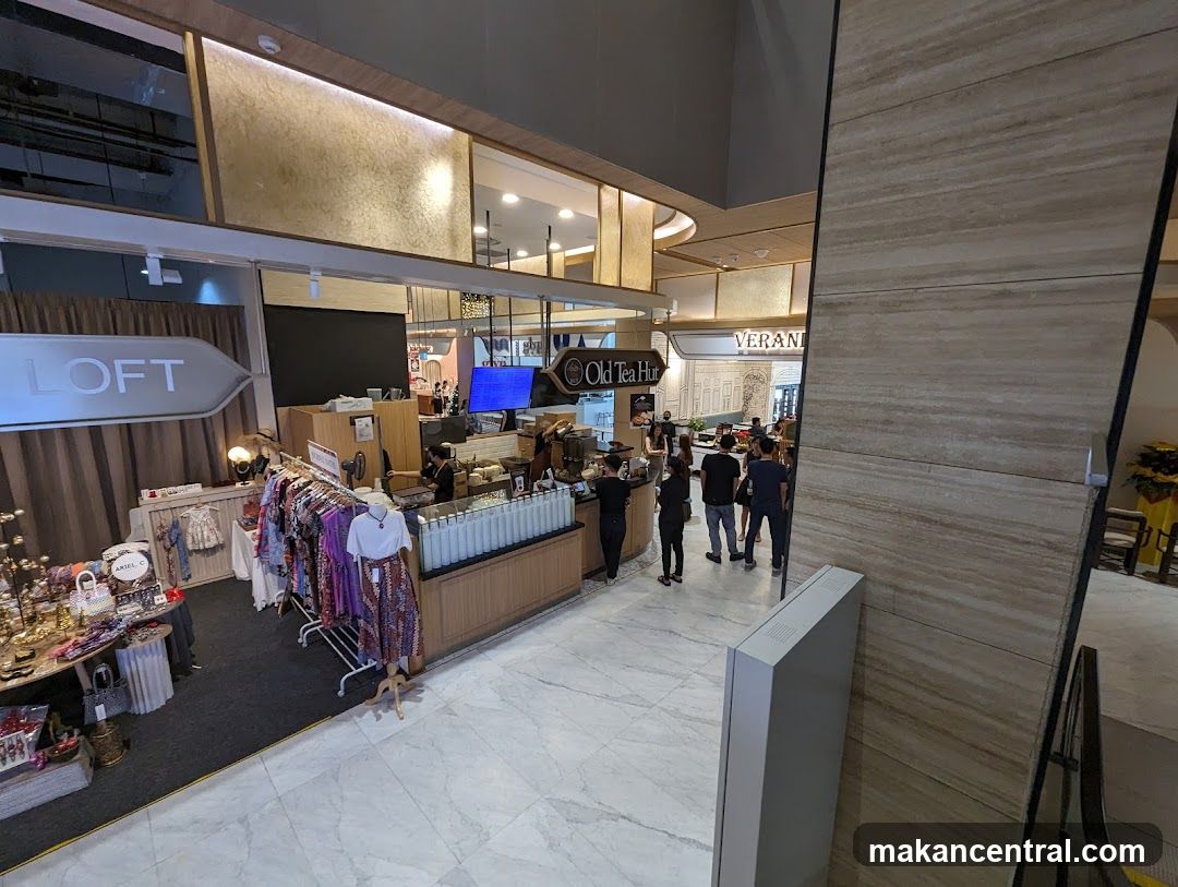 Interior of a shopping mall with shops and people
